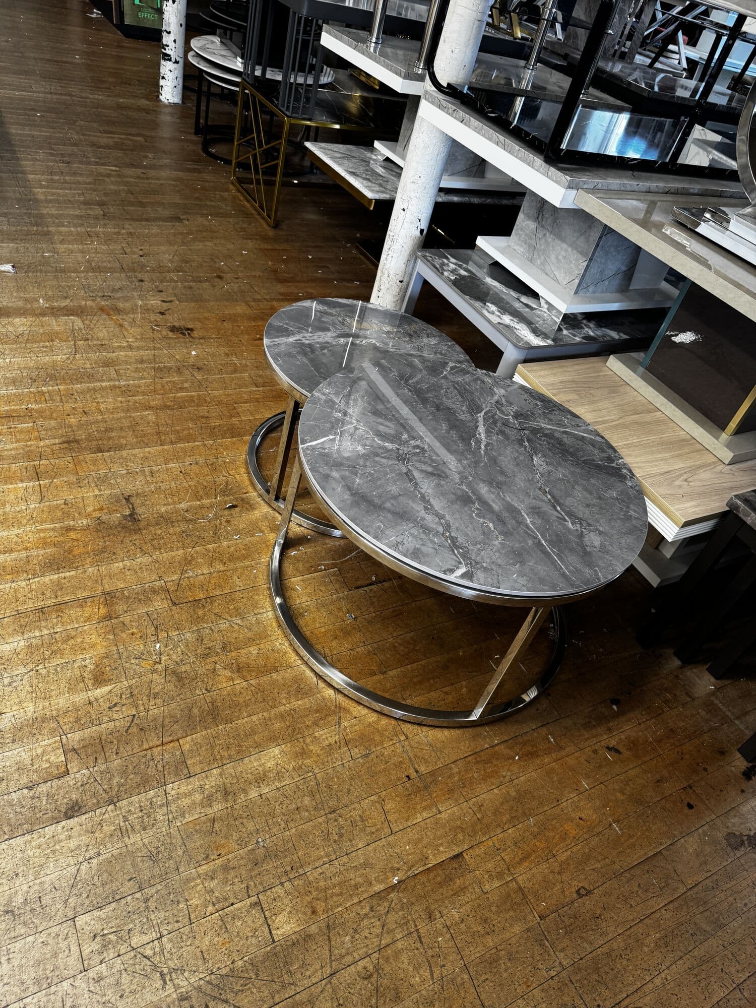Pair of round marble effect nesting tables on chrome frames