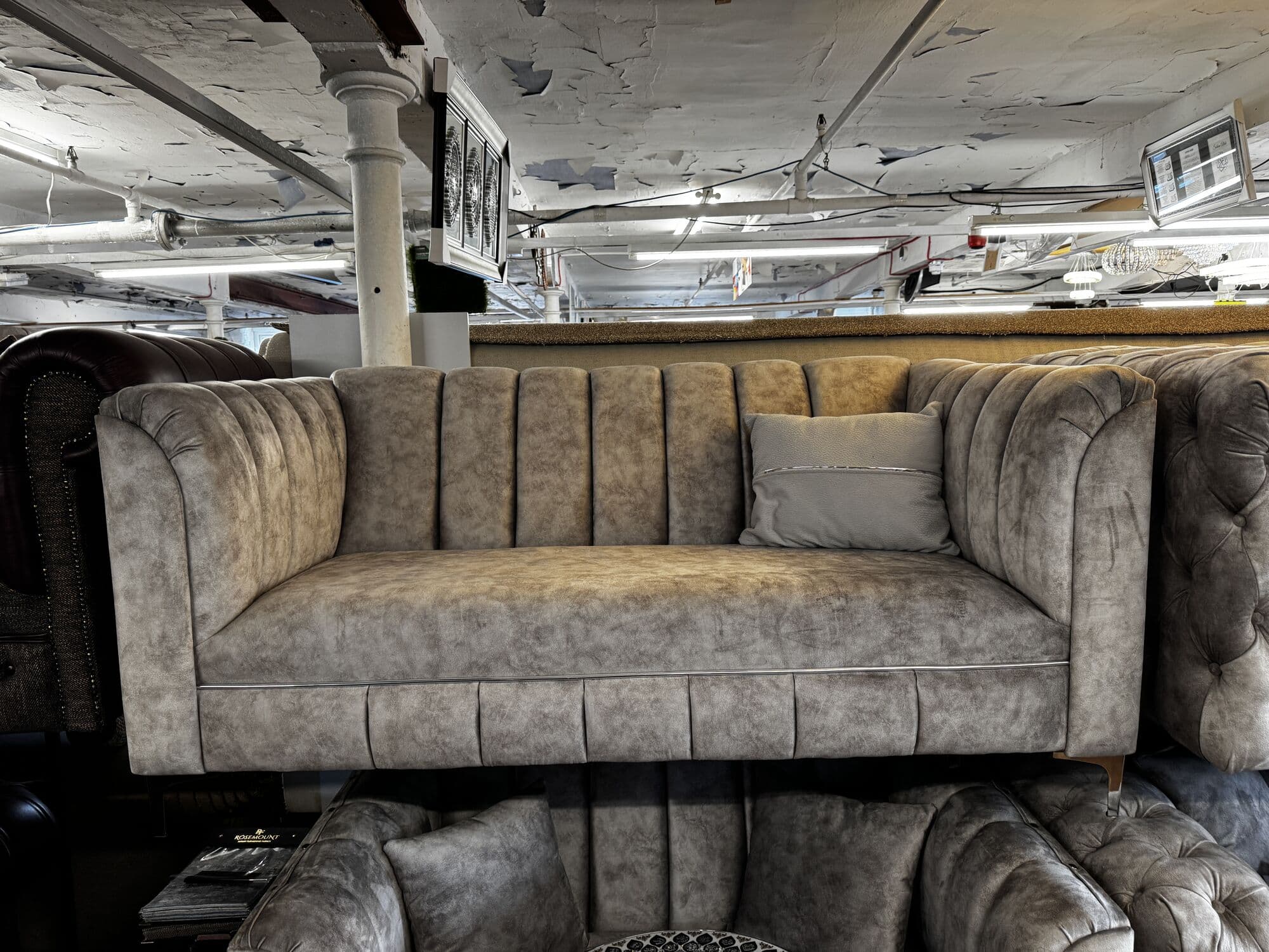 Mink fluted two seater sofa on the Derby Mill showroom floor