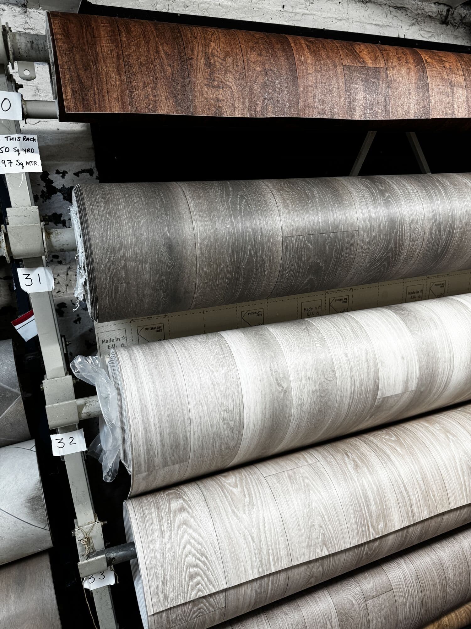 Wood effect vinyl flooring rolls on the numbered rack